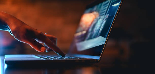 hand typing on computer keyboard
